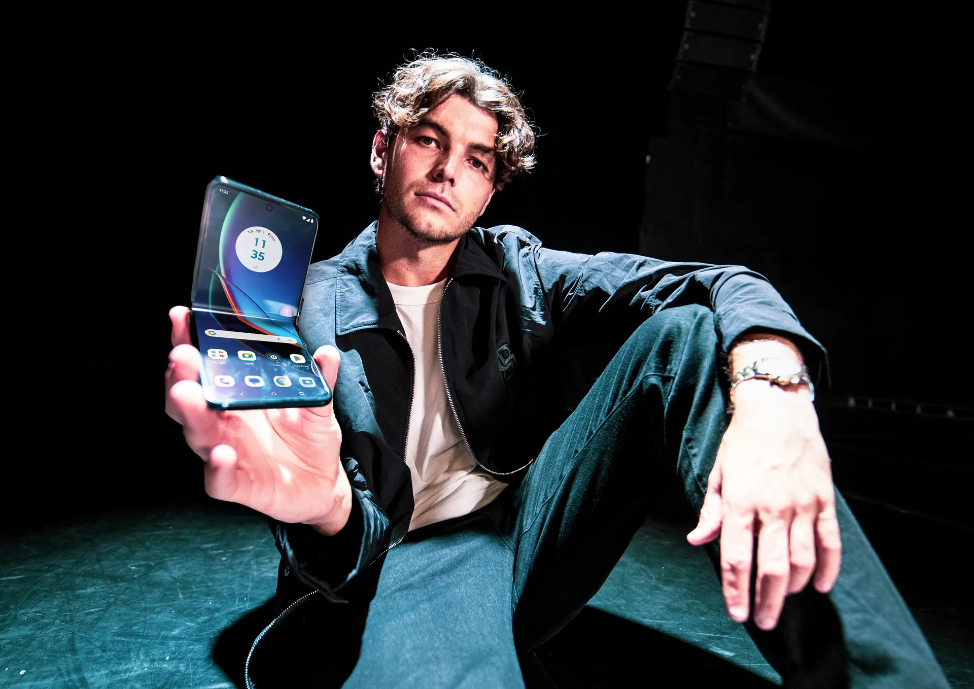 Lifestyle product photography of Taylor Fritz holding a Motorola Razr